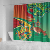 Wide shower curtain panel in red and green with ornate mask, bird, and 'Happy Mashramani'
