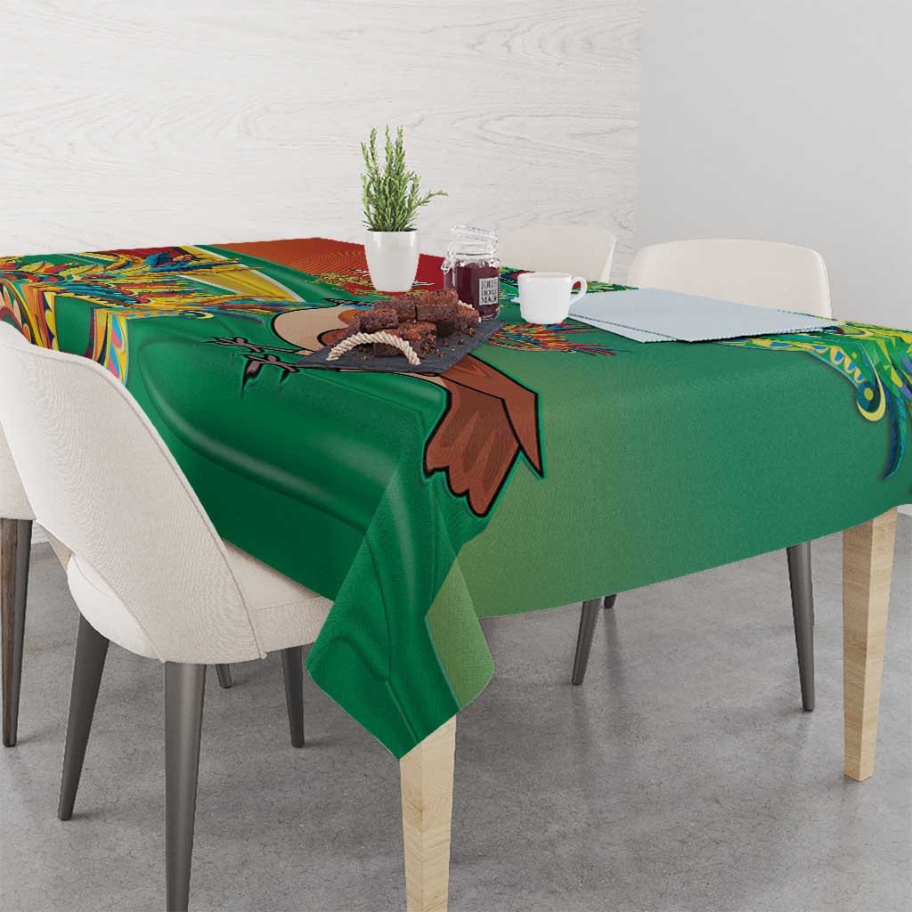 Green tablecloth with bird and floral motif, neatly spread across the tabletop