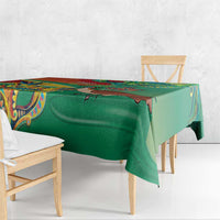 Green tablecloth corner view with colorful ornamental design along the edge