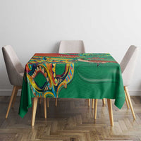 Green tablecloth with colorful patterned top and matching decorative border