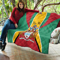 Guyana crest quilt blanket laid out on patio with green-red-yellow flag pattern