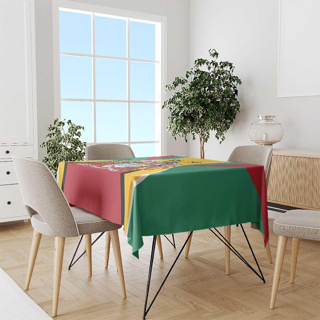 Guyana flag color tablecloth on dining table, red and green panels with yellow crest