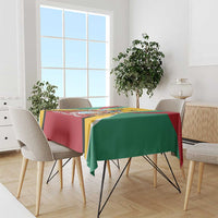 Guyana flag color tablecloth on dining table, red and green panels with yellow crest