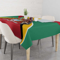 Guyana coat of arms tablecloth draped over table, red and green with yellow border