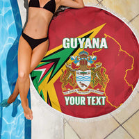 Red round beach blanket with fringe edge, Guyana crest and 'YOUR TEXT' centered graphic.