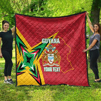 Red quilted blanket hanging outdoors with Guyana map, crest, starburst, and custom text