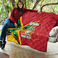 Red quilted blanket on patio with Guyana map and crest, starburst, and custom text