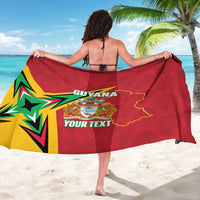 Red Guyana sarong held wide, showing flag emblem and custom text in center