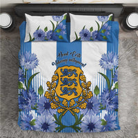 Blue bedding set with cornflower floral print, central crest, and two white pillowcases