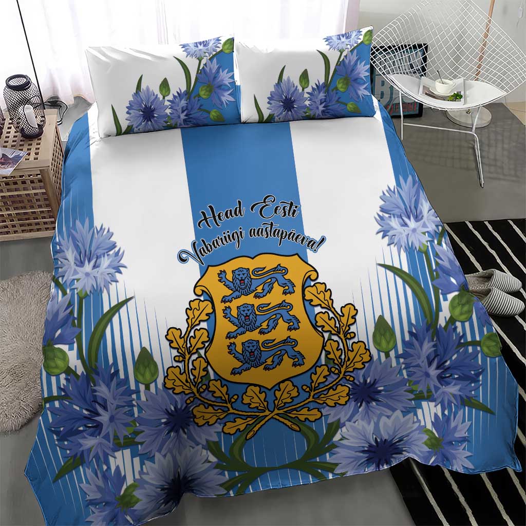 Blue bedding set with floral cornflower design, central crest, and two coordinating pillowcases