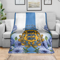 Estonia Independence Day blanket on sofa, blue floral border with central crest and stripes