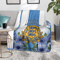 Estonia Independence Day blanket on floor, blue floral print with central crest and stripes