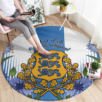 Blue round rug with central golden crest, “Eesti” script, and leaf-pattern border