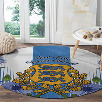 Blue round rug with golden crest, blue script text, and pine-leaf patterned border