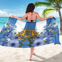 Blue Estonia-themed sarong, back view, with blue flowers and golden coat-of-arms crest