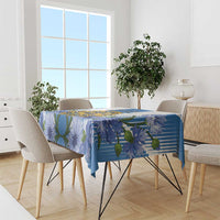 Blue tablecloth with bold stripes and large blue flower print over dining table