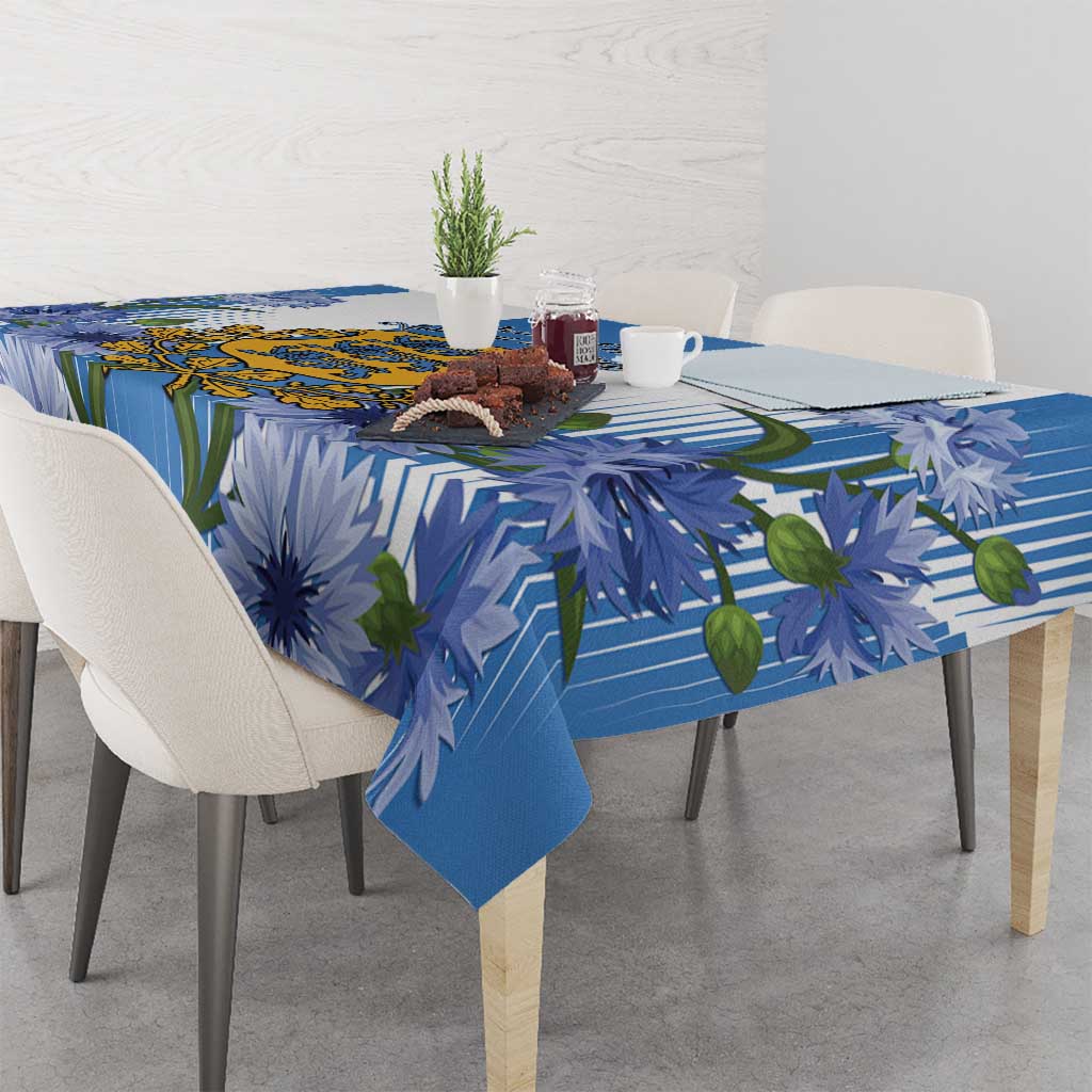 Blue tablecloth with stripe and blue flower print, draped over dining table