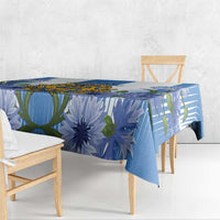 Blue tablecloth with large blue floral and leaf graphics, draped on bench table