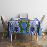 Blue tablecloth with crest center and large blue flower print on dining table