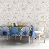 Blue tablecloth with crest and blue flower-and-leaf print on dining table