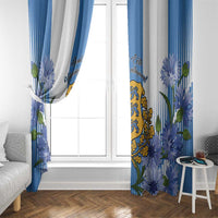 Blue and white window curtains with floral border and central coat of arms design