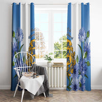 Blue and white window curtains with vertical striped pattern, florals, and coat of arms