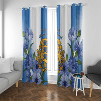 Blue and white window curtains with floral print, central coat of arms, and top hooks