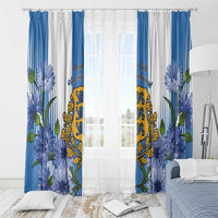 Blue and white window curtains with layered florals and central coat of arms graphic