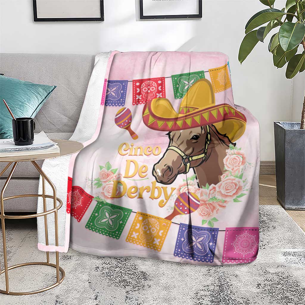 Pink horse blanket on floor with sombrero horse portrait, floral roses, and colorful banner flags.