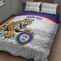White quilt with jaguar graphic and blue/red stripe band, styled with 2 patterned pillows