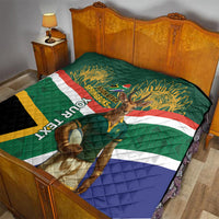 Green South Africa rugby quilt on a bed with Springboks text, mascot image, and geometric stripes.