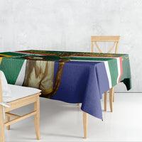 Rugby tablecloth draped on wooden chairs; green, blue, red and white diagonal stripe design.