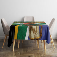 Rugby tablecloth on dining table; green and blue center panel with gold and white accents.