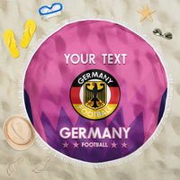 Pink round Germany football beach blanket with white fringe and circular emblem