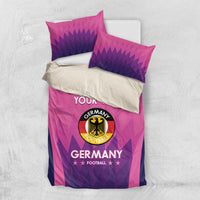 Pink Germany football bedding set shown with duvet and two purple patterned pillowcases