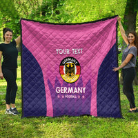 Pink and navy Germany football quilt shown hanging outdoors, “YOUR TEXT” and crest