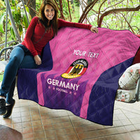 Pink and navy Germany football quilt laid on patio, “YOUR TEXT” and crest and “GERMANY”