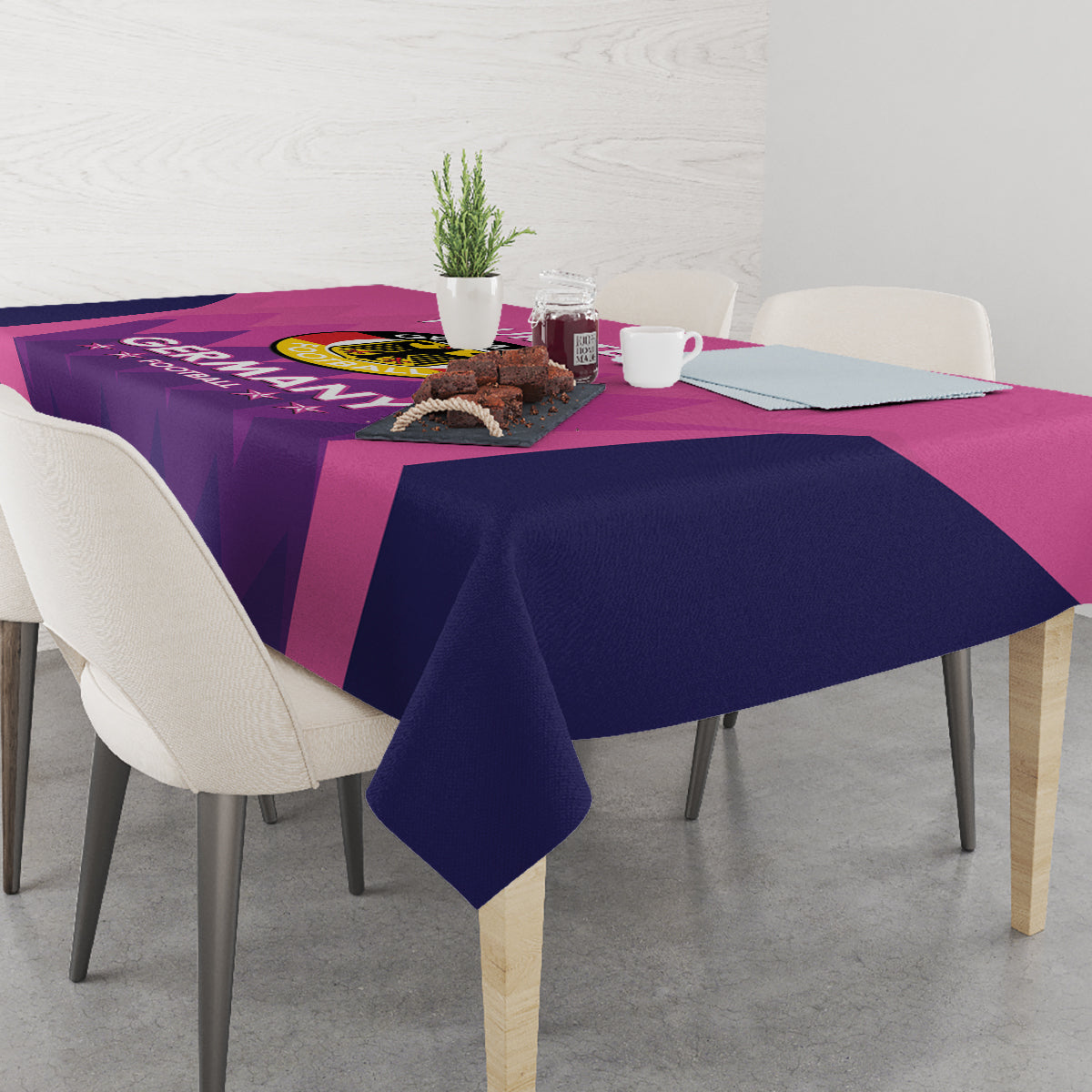 Pink and dark blue football tablecloth with Germany crest, draped over table