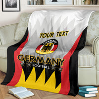White Germany football blanket with custom “YOUR TEXT” and Germany crest on sofa