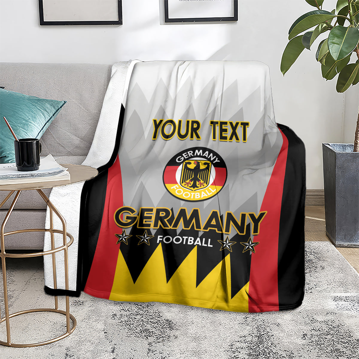 White Germany football blanket with Germany crest and “YOUR TEXT” over armchair seating