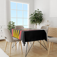 Football-themed tablecloth draped on a dining table with black red yellow design