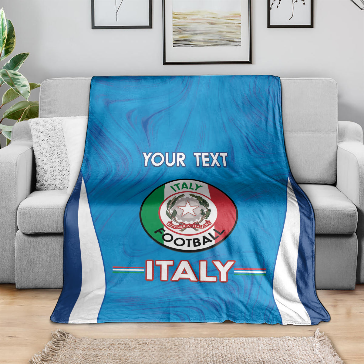Blue Italy football blanket with white side stripes, Italy crest and custom text on couch