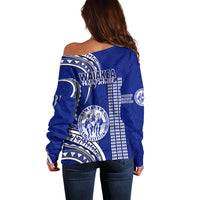Blue off-shoulder sweater back view with Polynesian pattern and school crest