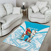 Blue area rug featuring macaw artwork on a white and light-blue geometric background