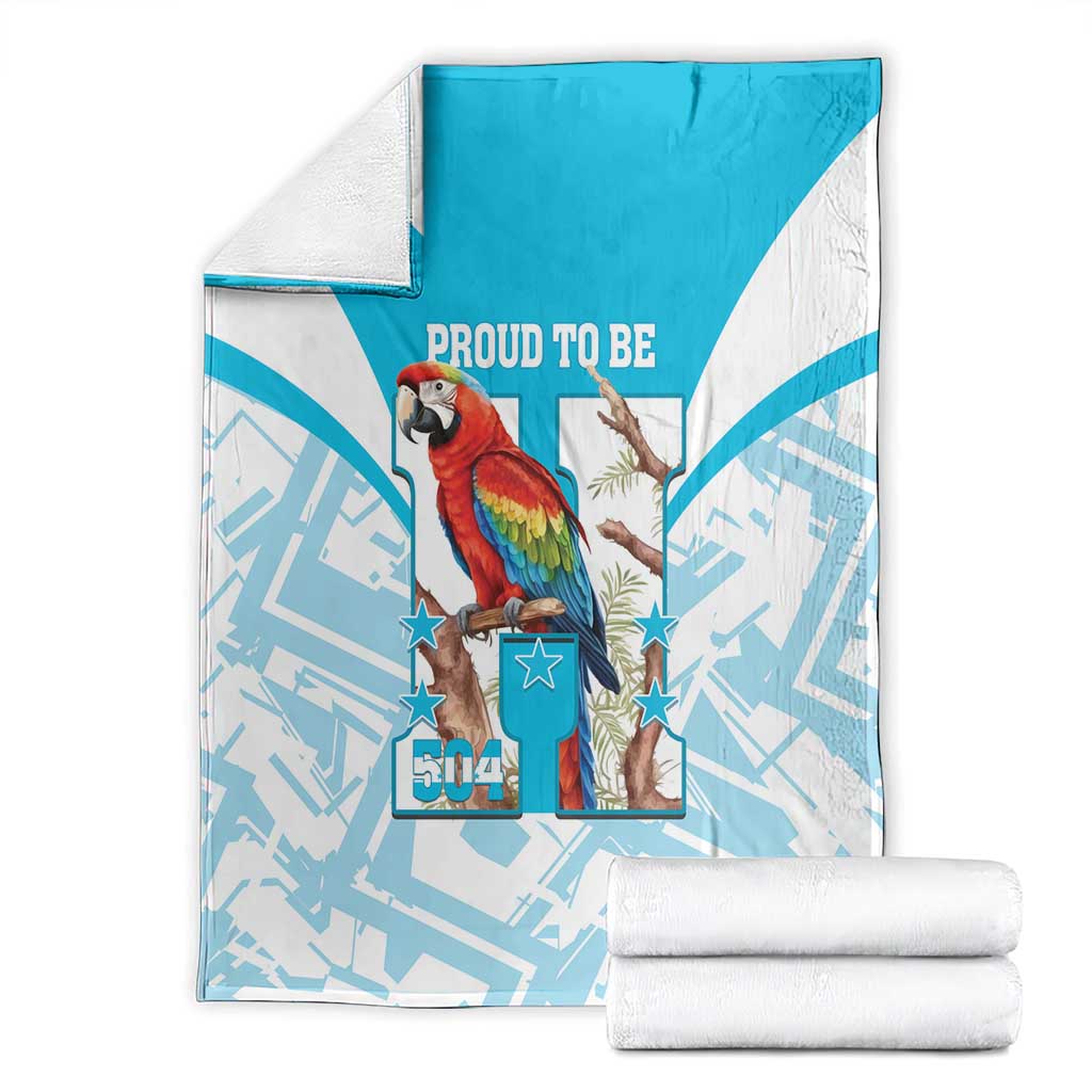 Folded blue-and-white blanket with scarlet macaw artwork, stars, and “Proud to Be 504”