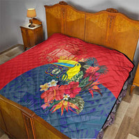 Tropical red and blue quilt on a bed with toucan, flowers, and Belize 501