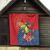 Red and blue quilt with toucan bouquet design and Belize 501 patch on wall