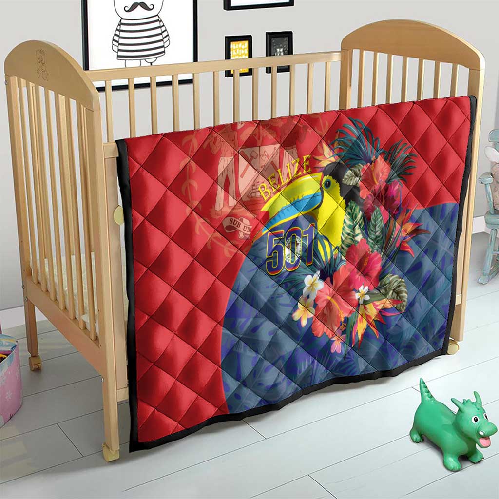 Red and blue quilt with toucan and flowers, Belize 501 on a baby bed