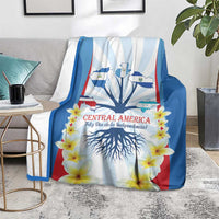 Independence Day blanket on a sofa with tree roots, stripes, and bright yellow flowers