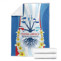 Folded Independence Day blanket with blue-and-white stripes, tree roots, and yellow flowers